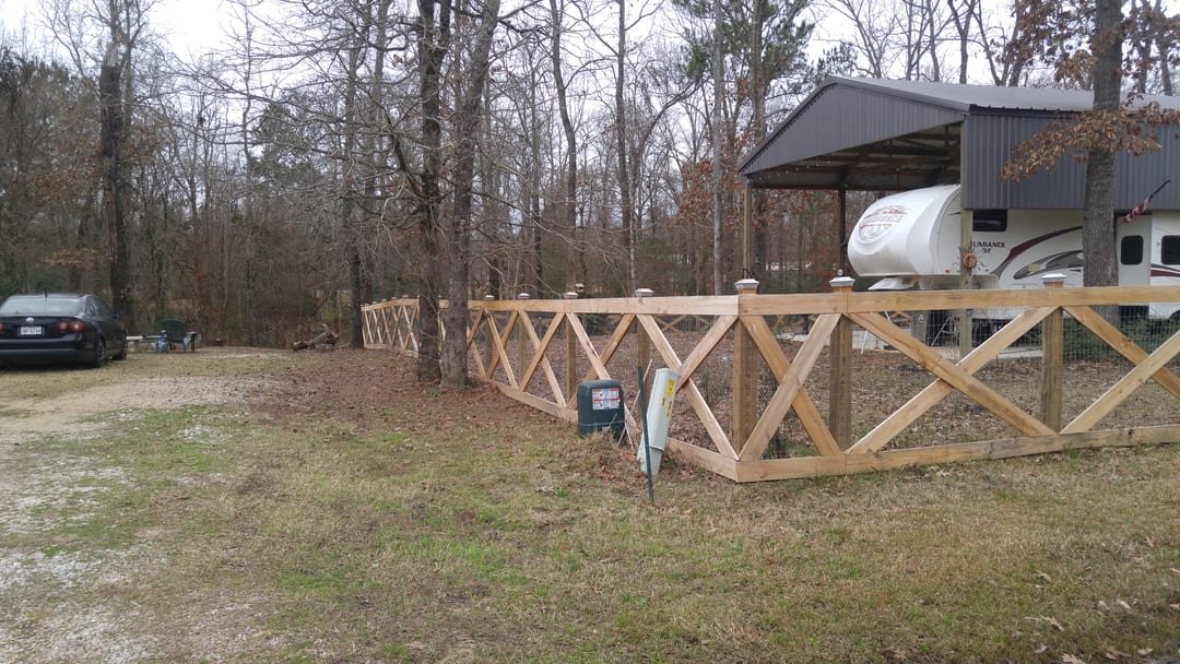 Cross buck wood fence lining a ranch driveway