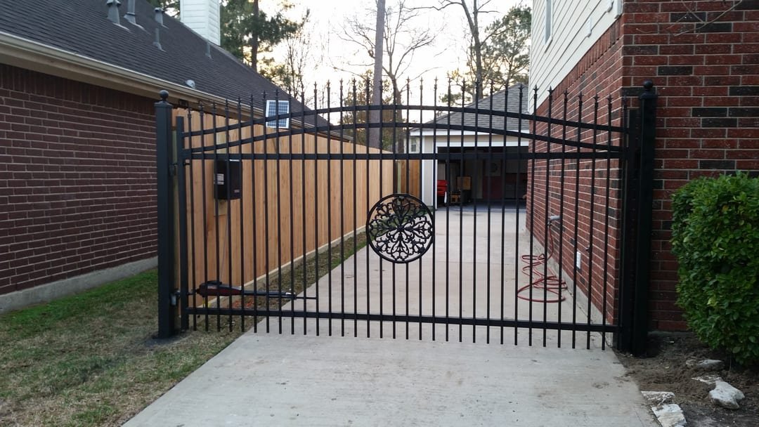Ornamental metal driveway gate with an automatic opener