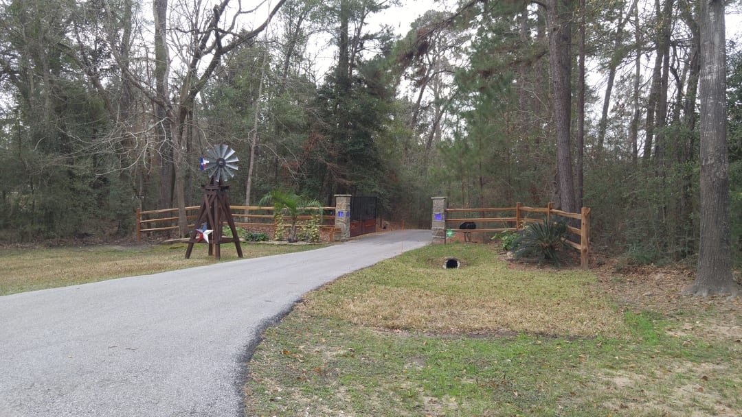 Steel security gate at a driveway entrance