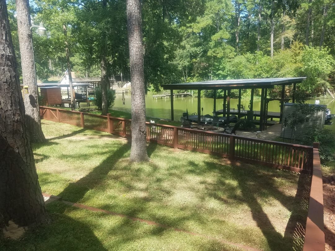 New wood deck with handrail built by Texas Rural Fence